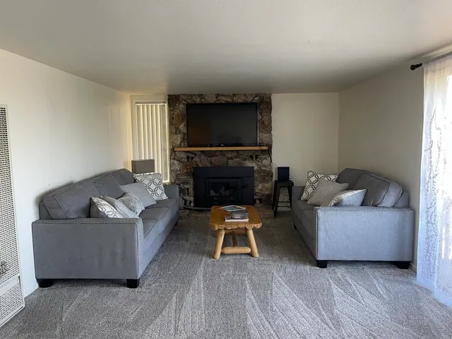 a large bed sitting in a bedroom next to a window