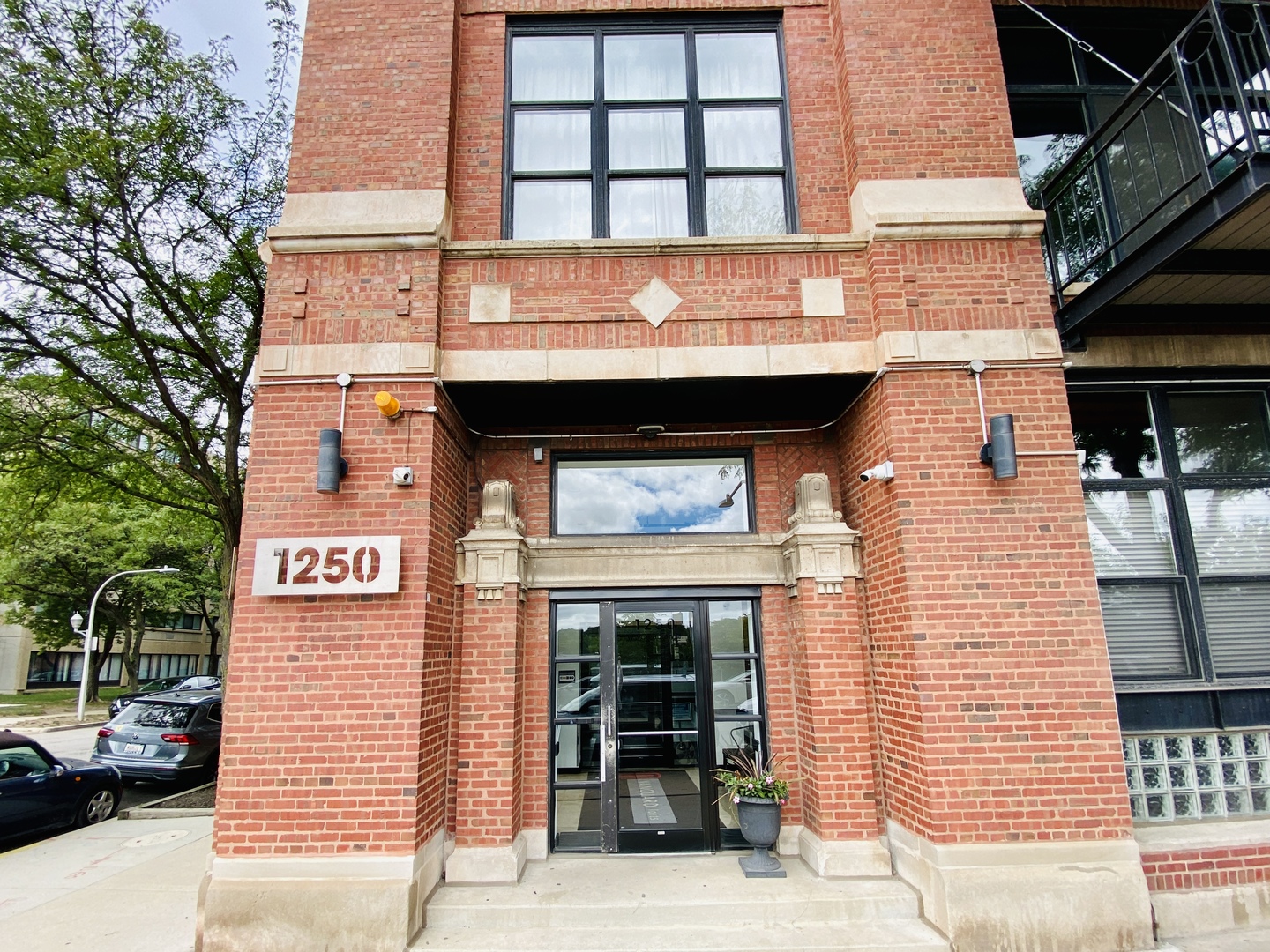 1250 West Van Buren Street, Unit 201 Chicago, IL 60607 - Photo 1 of 2 a view of a brick building with large windows