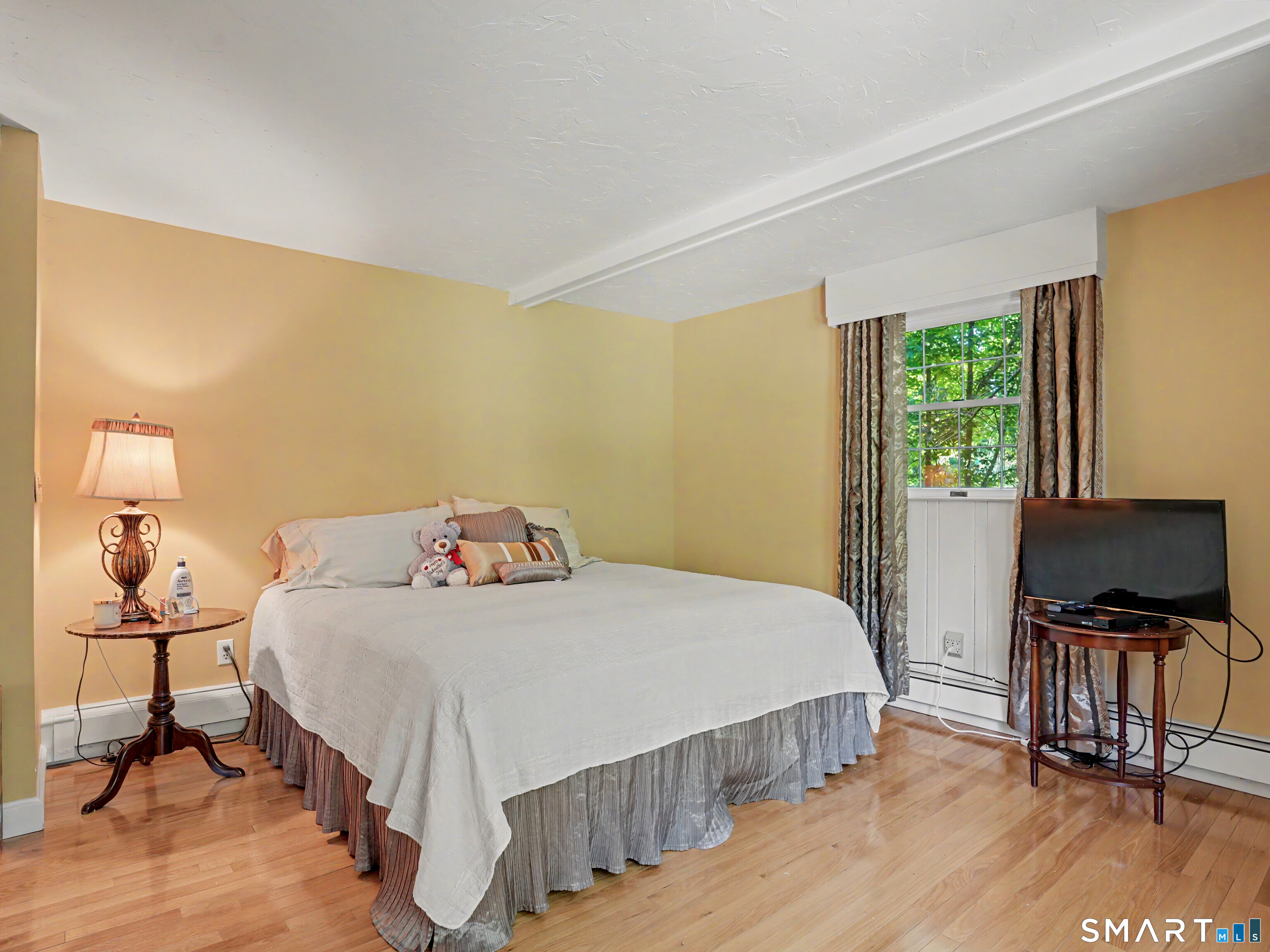 15 Flat Rock Drive Ridgefield, CT 06877 - Photo 24 of 39 a bedroom with a bed and wooden floor