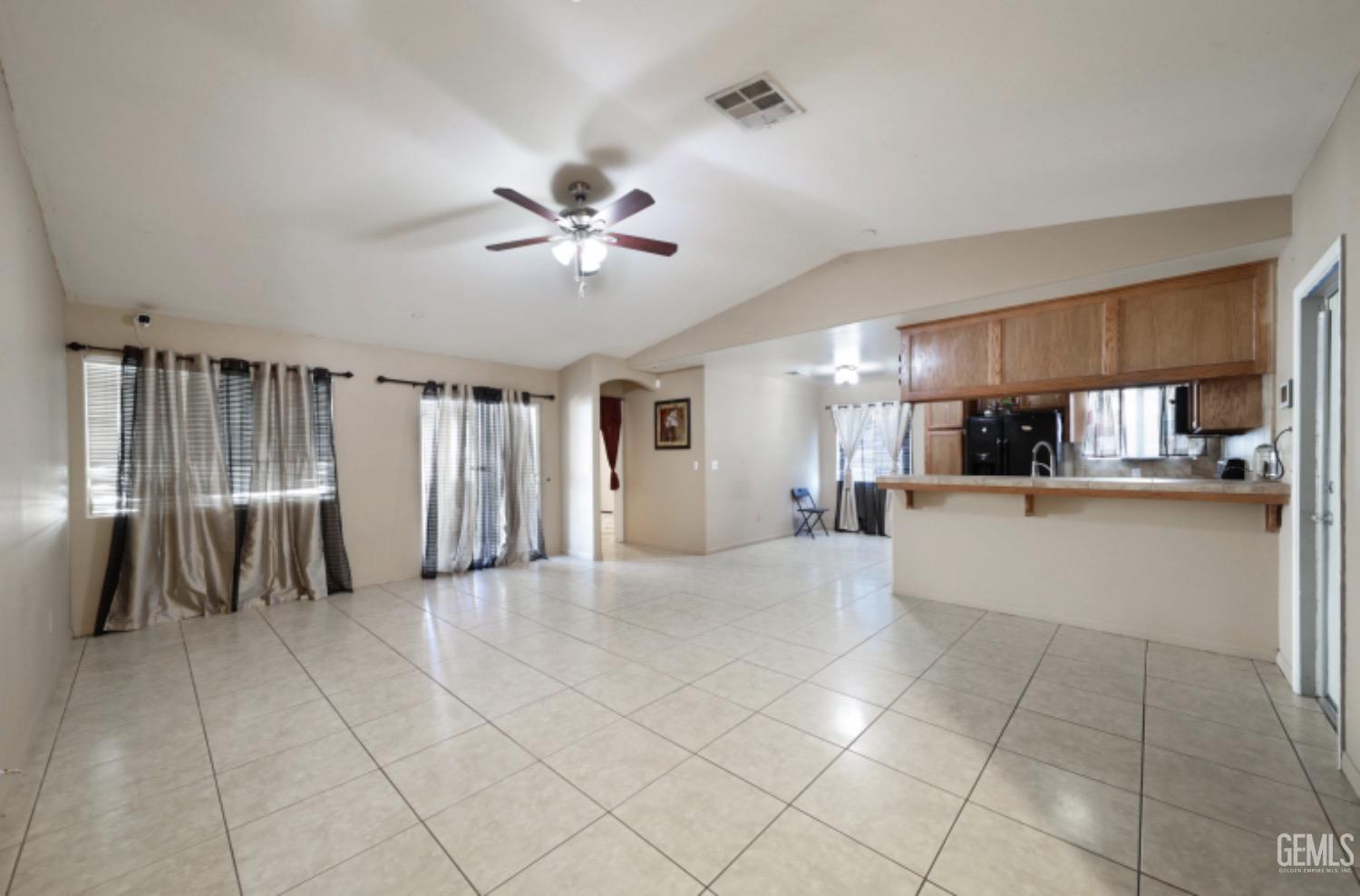 Undisclosed Address Bakersfield, CA 93306 - Photo 12 of 21 a view of a livingroom with a furniture cabinets and a kitchen