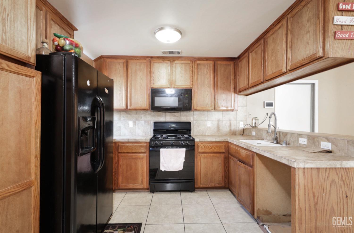 Undisclosed Address Bakersfield, CA 93306 - Photo 15 of 21 a kitchen with a sink stove and refrigerator