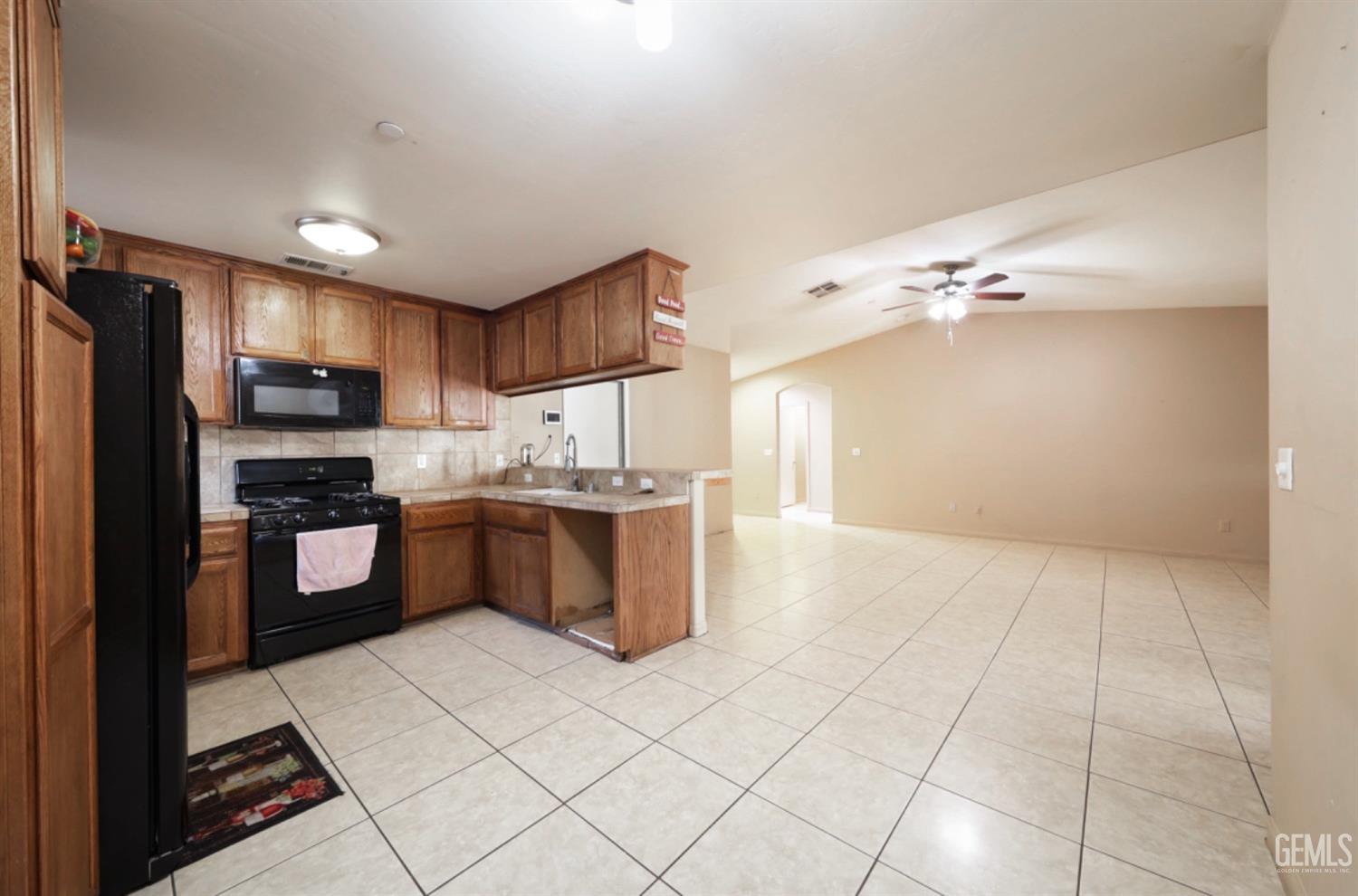 Undisclosed Address Bakersfield, CA 93306 - Photo 16 of 21 a large kitchen with a large counter top stainless steel appliances and cabinets