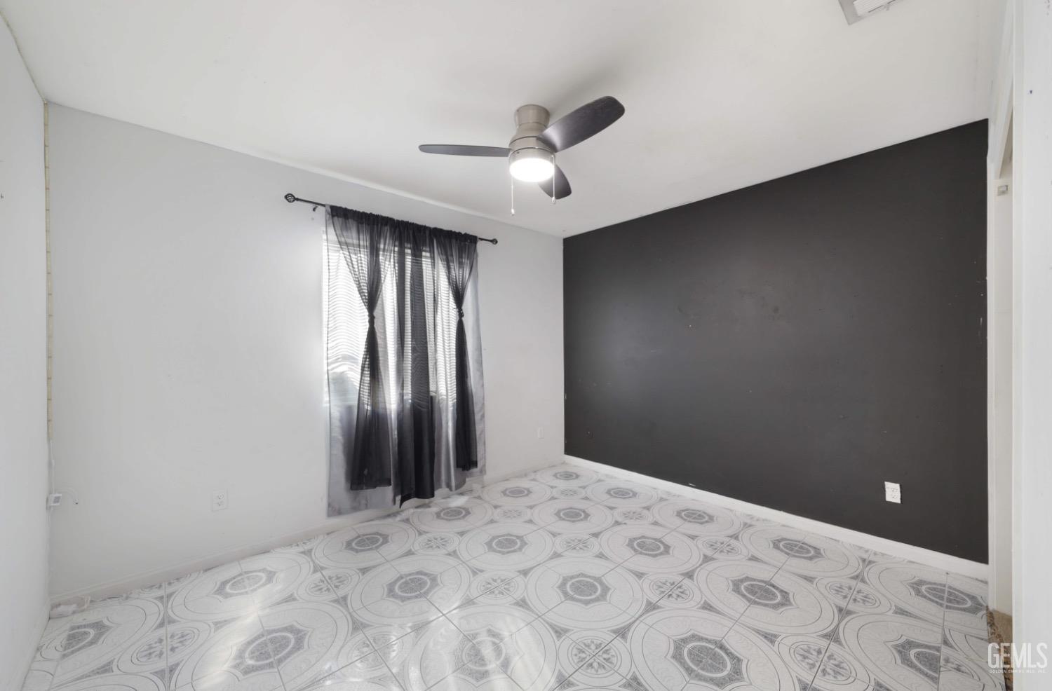 Undisclosed Address Bakersfield, CA 93306 - Photo 6 of 21 a bedroom with a large bed and a chandelier