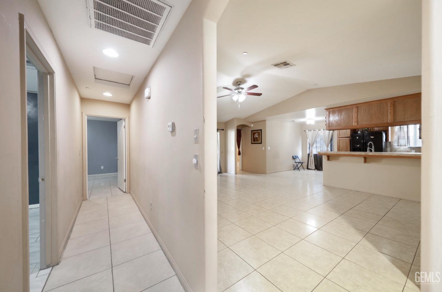 Undisclosed Address Bakersfield, CA 93306 - Photo 10 of 21 a view of a hallway with furniture and a kitchen