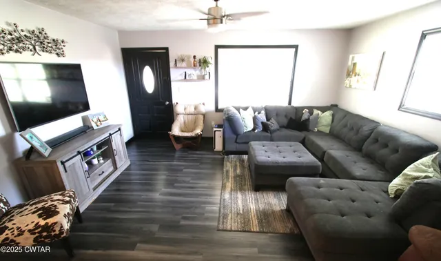 a living room with furniture and a flat screen tv