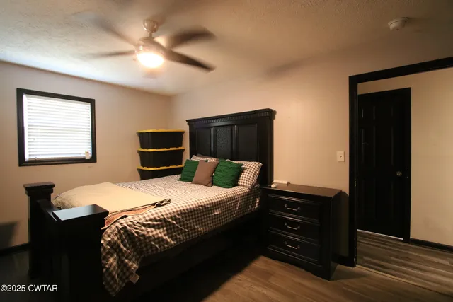 a bedroom with a bed and a dresser