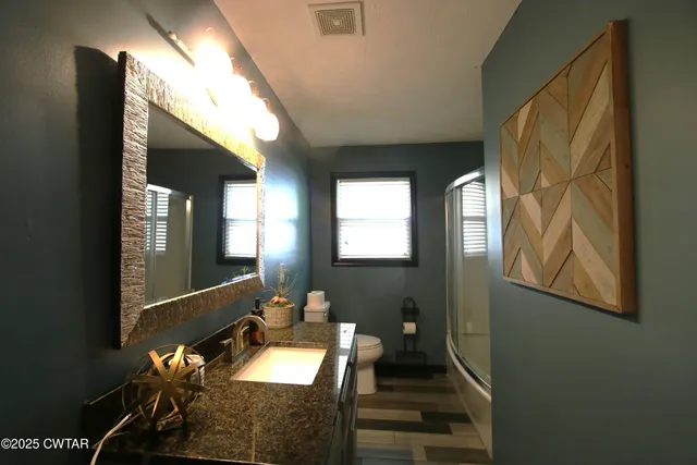 a balcony with wooden floor and furniture