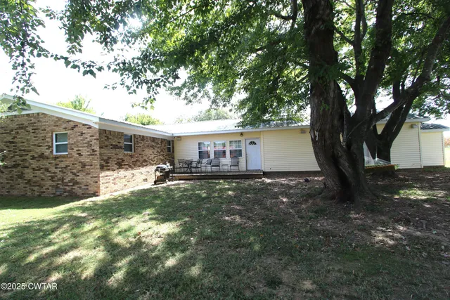 a view of house with yard and entertaining space