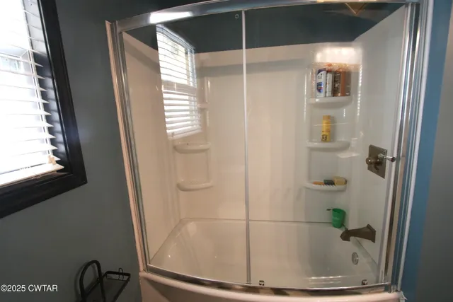 a bathroom with a glass shower door