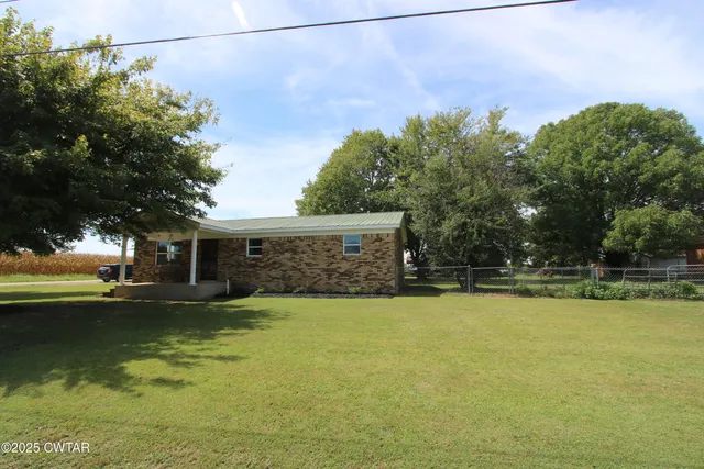 a view of a swimming pool with an outdoor space and seating area