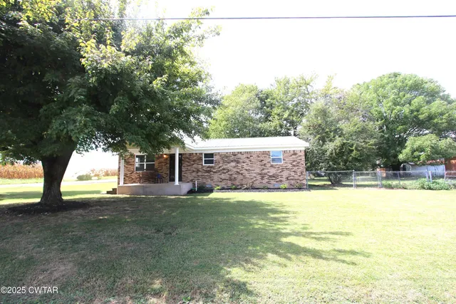 a view of a backyard with large trees