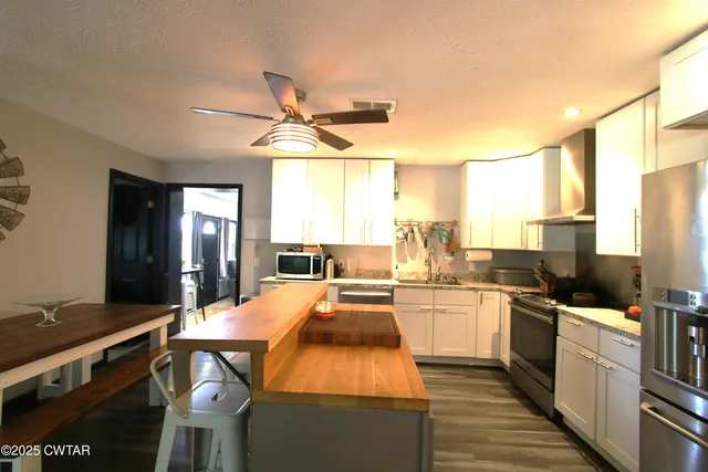 a kitchen with a sink appliances and cabinets
