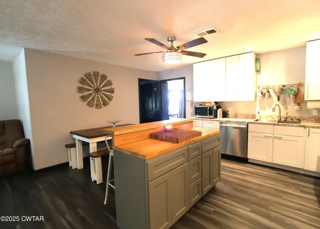 a kitchen with a stove a sink and a refrigerator