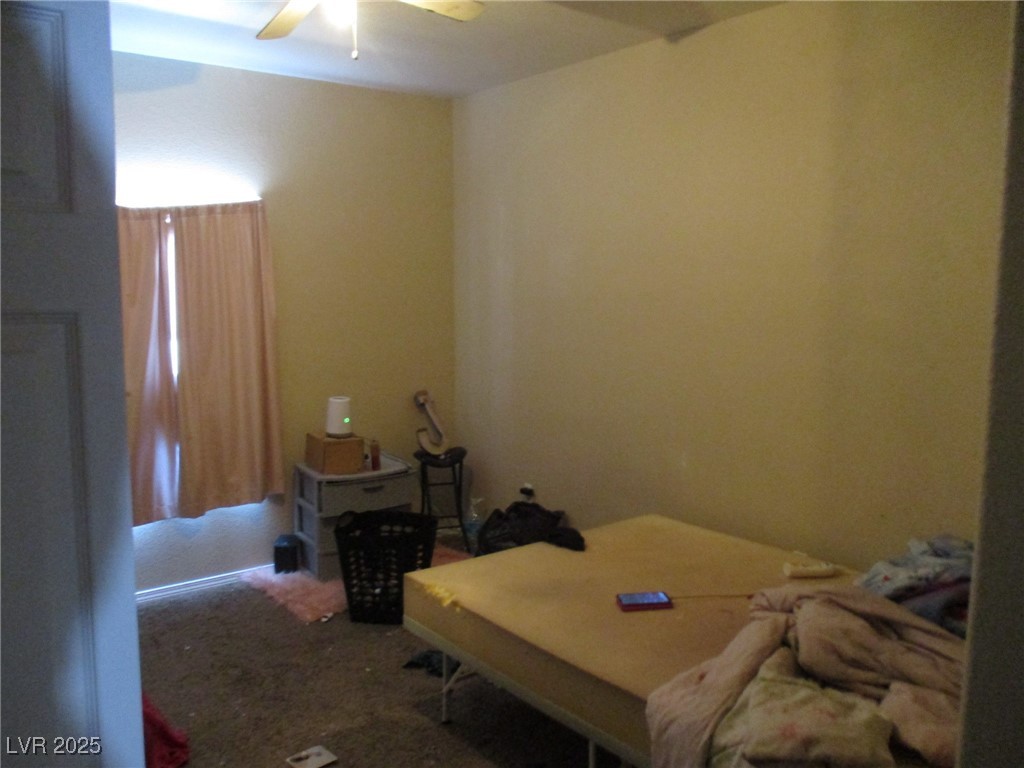3318 North Decatur Boulevard, Unit 1044 Las Vegas, NV 89130 - Photo 15 of 18 Bedroom featuring a ceiling fan and carpet floors