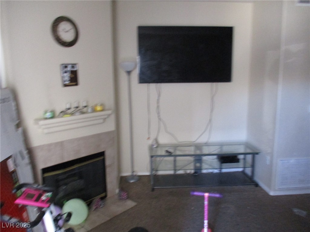 3318 North Decatur Boulevard, Unit 1044 Las Vegas, NV 89130 - Photo 2 of 18 Living area featuring visible vents and a fireplac