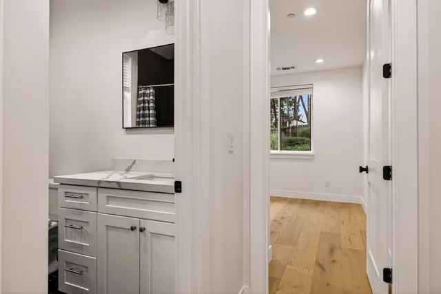 a view of a room with wooden floor