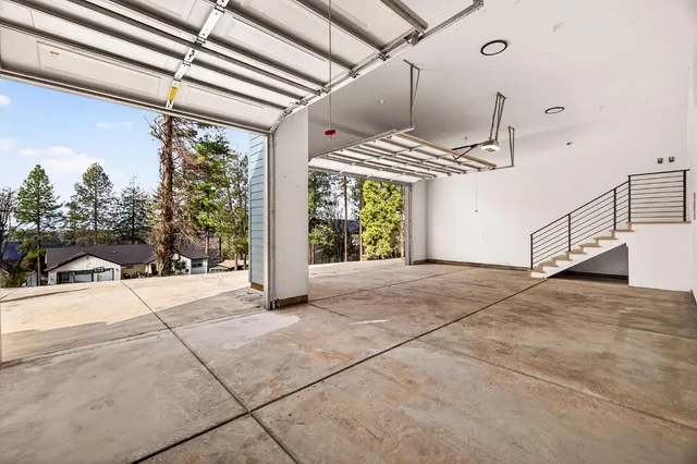 an aerial view of a house with yard and outdoor seating