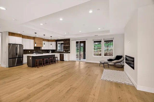 a kitchen with stainless steel appliances a refrigerator and a stove top oven
