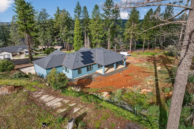 an aerial view of multiple houses with yard