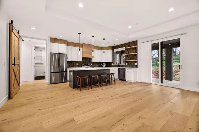 a kitchen with stainless steel appliances kitchen island granite countertop a sink and cabinets