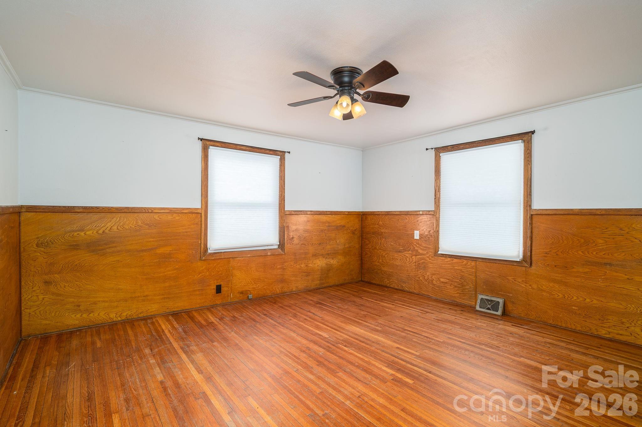610 Washington Street Cramerton, NC 28032 - Photo 18 of 41 a view of empty room with wooden floor and fan