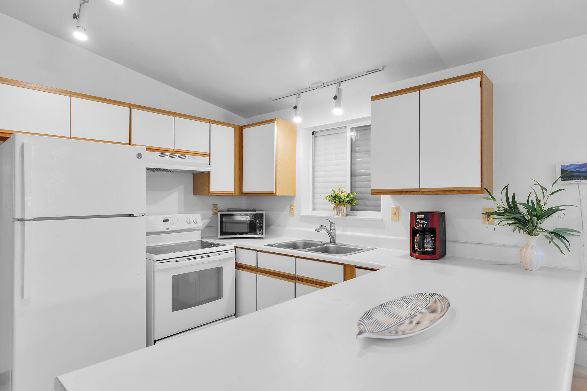 30625 16th Lane Big Pine Key, FL 33043 - Photo 19 of 42 a kitchen with white cabinets and white appliances