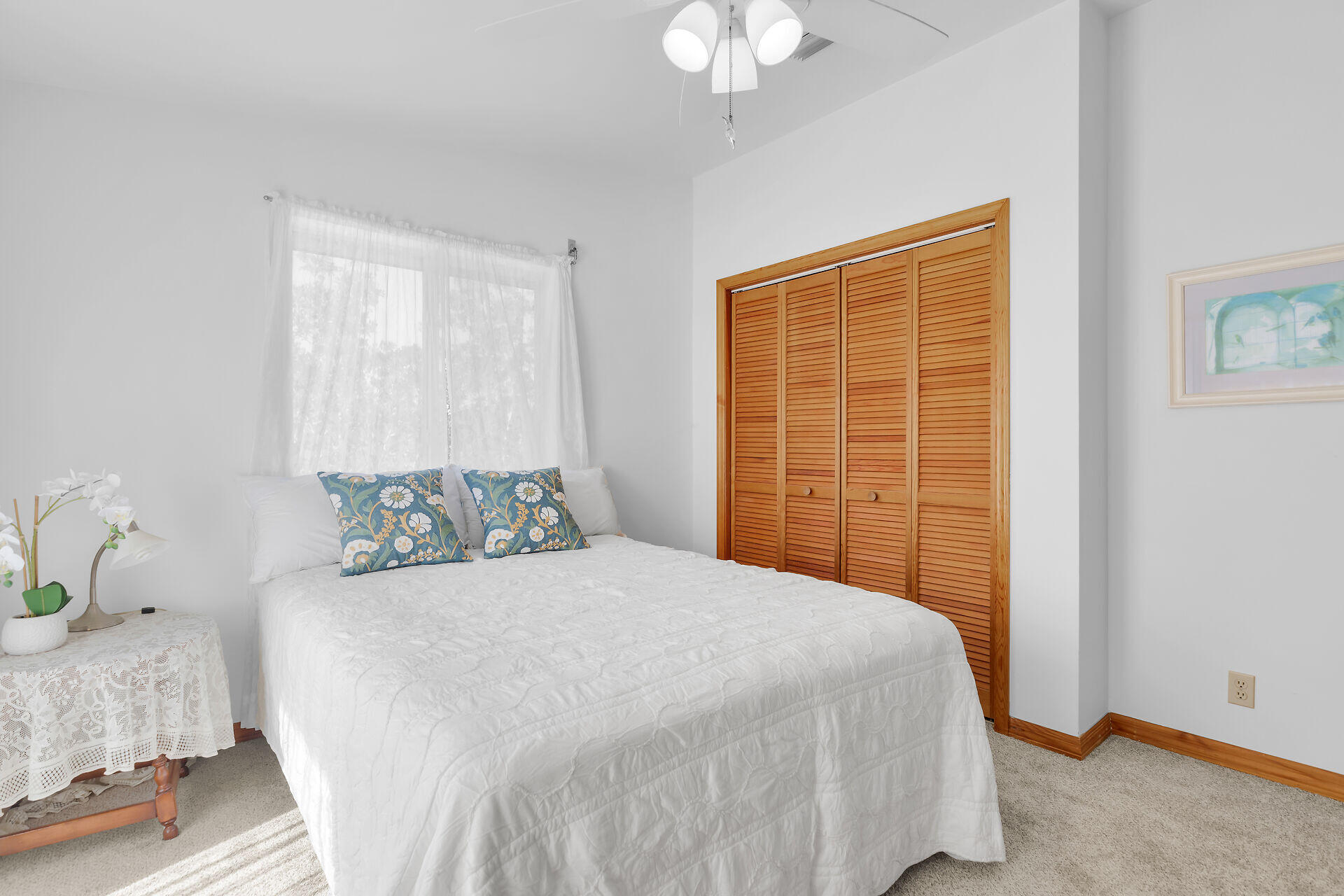 30625 16th Lane Big Pine Key, FL 33043 - Photo 24 of 42 a bedroom with a large bed and a chandelier