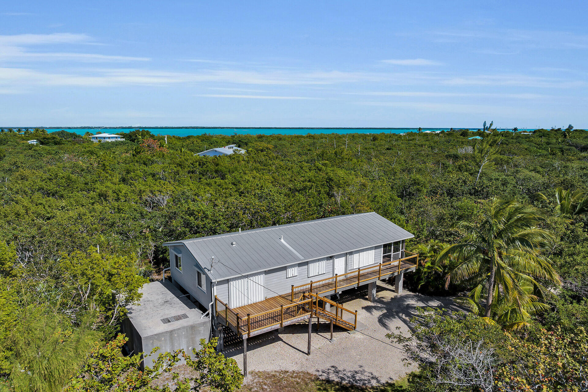 30625 16th Lane Big Pine Key, FL 33043 - Photo 32 of 42 a view of a patio with table and chairs under an umbrella