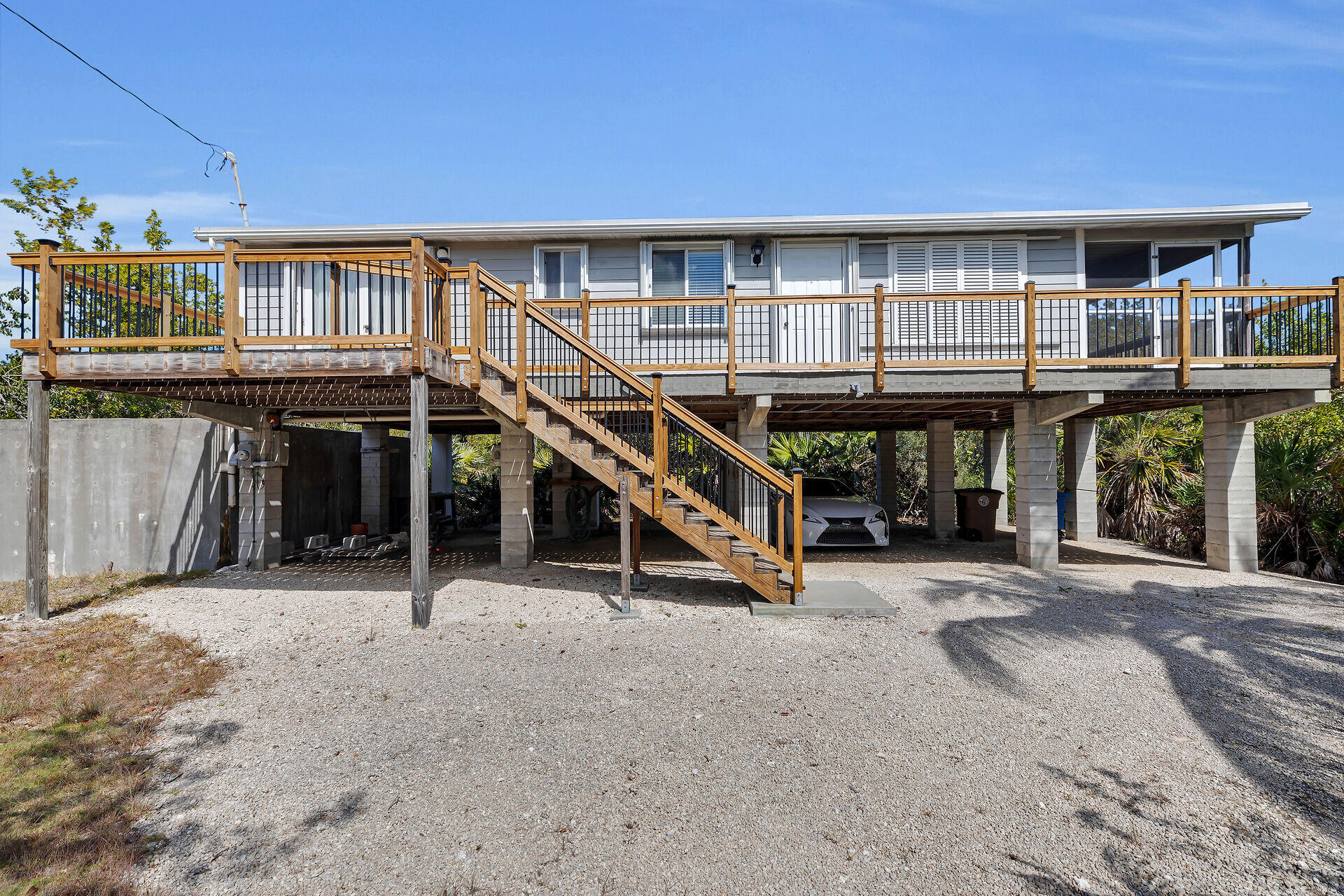 30625 16th Lane Big Pine Key, FL 33043 - Photo 6 of 42 a view of house with large windows and stairs