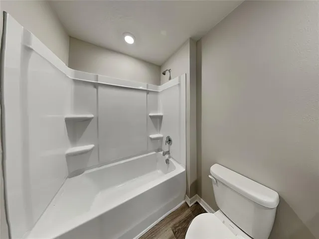 a bathroom with a toilet and a bathtub