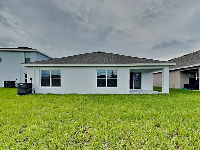 a house that has a big yard with large trees
