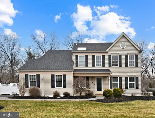 a front view of house with yard and trees around