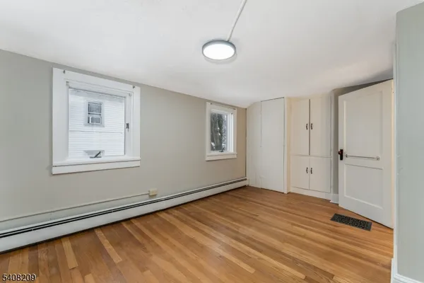a view of a room with wooden floor and window