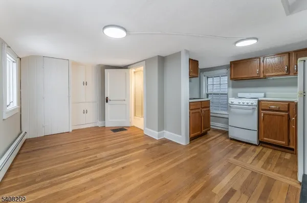 a view of kitchen with stainless steel appliances granite countertop a stove and a refrigerator