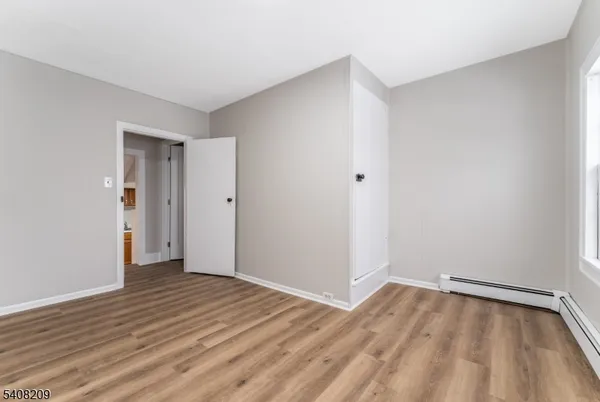 a view of an empty room and wooden floor