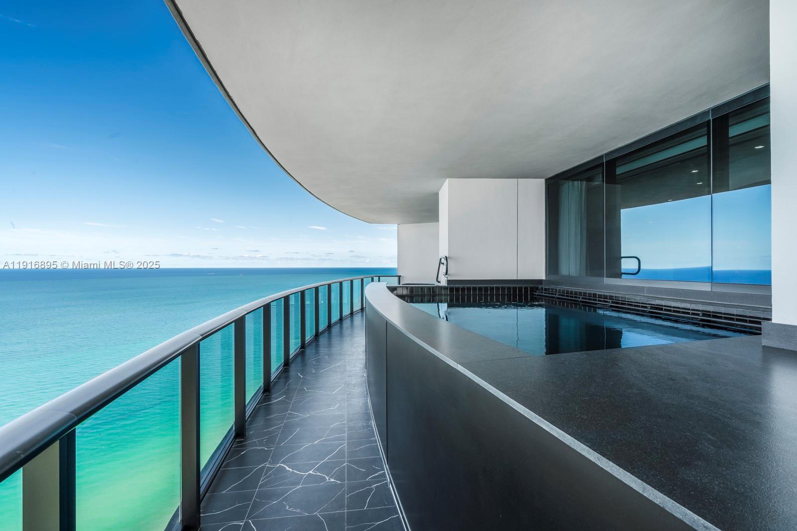 18555 Collins Avenue, Unit 3505 Sunny Isles Beach, FL 33160 - Photo 17 of 52 a view of a kitchen with kitchen island a sink a stove and a oven