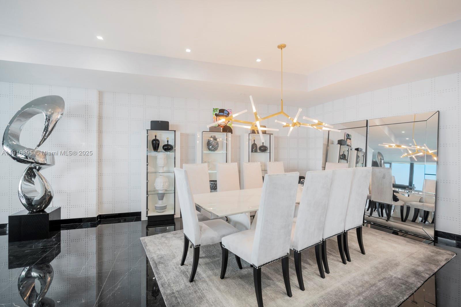 18555 Collins Avenue, Unit 3505 Sunny Isles Beach, FL 33160 - Photo 4 of 52 a view of a dining room with furniture and wooden floor