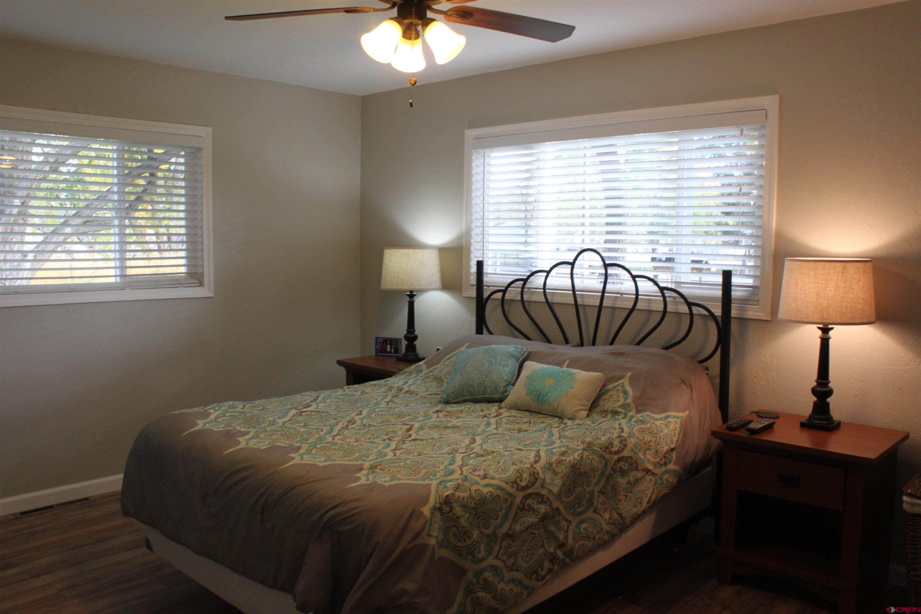 20976 6840th Road Montrose, CO 81403 - Photo 11 of 33 a bedroom with a bed and a lamp