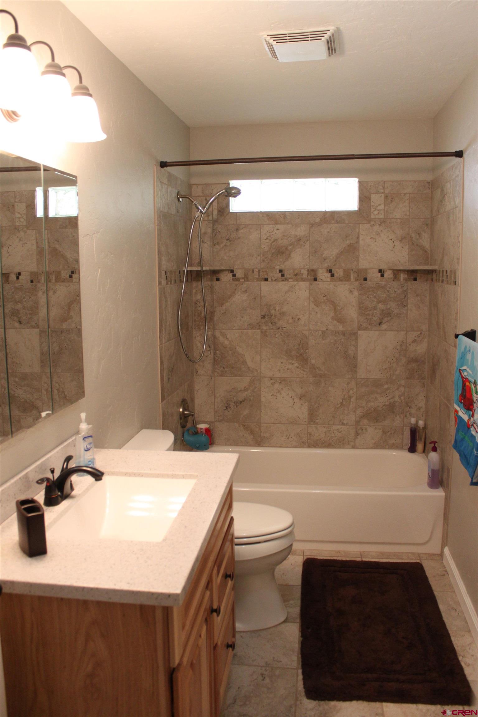 20976 6840th Road Montrose, CO 81403 - Photo 13 of 33 a bathroom with a sink a toilet and a bathtub