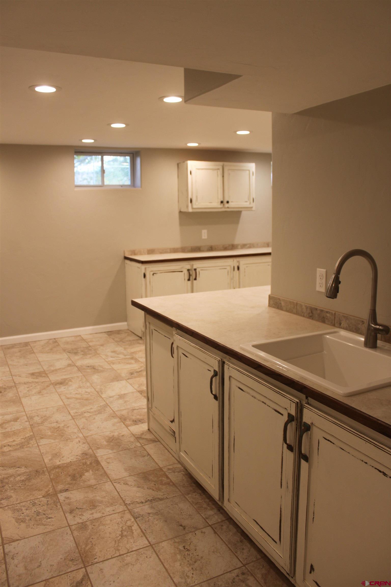 20976 6840th Road Montrose, CO 81403 - Photo 16 of 33 a view of a kitchen with a sink and a refrigerator