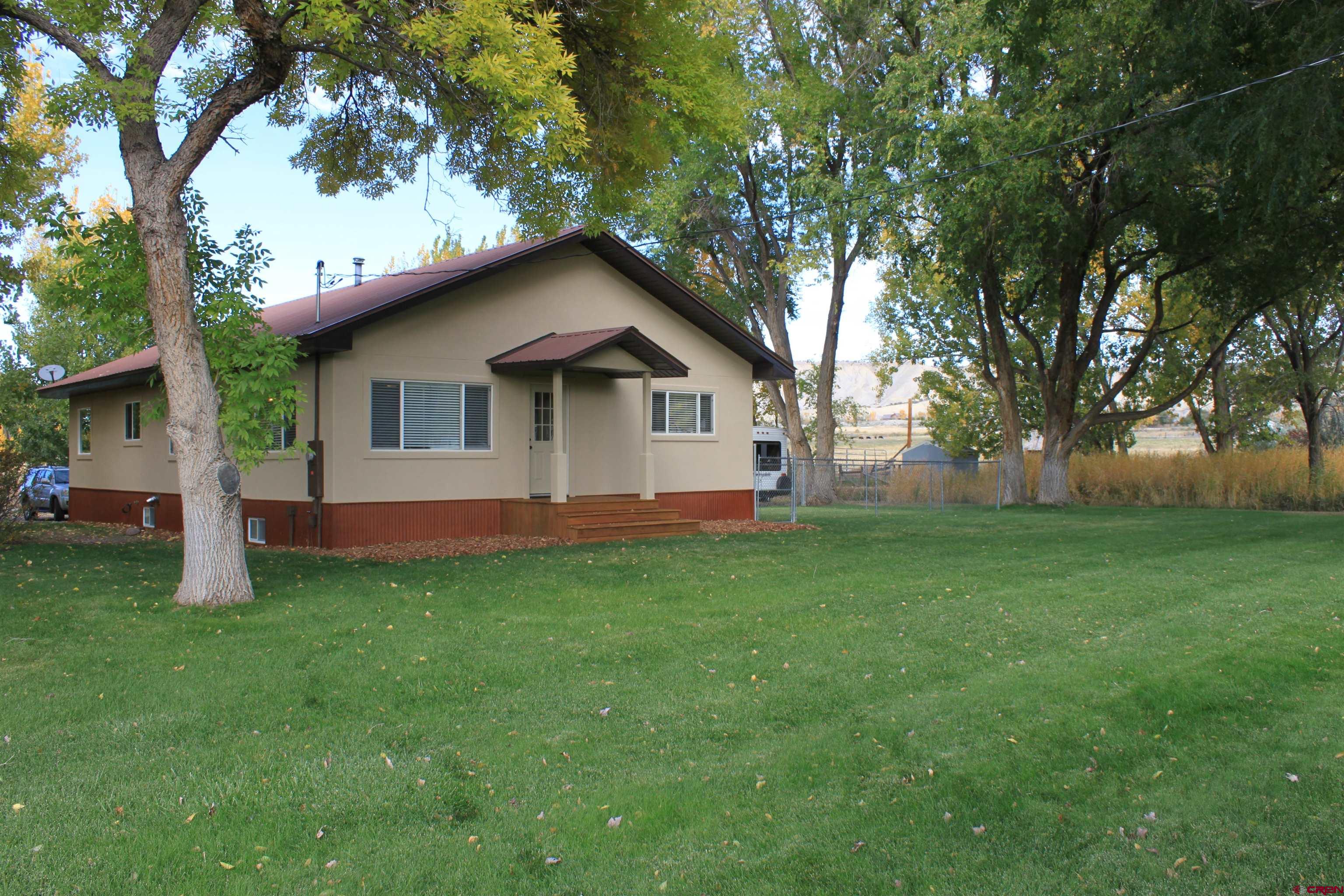20976 6840th Road Montrose, CO 81403 - Photo 31 of 33 a front view of house with yard and green space