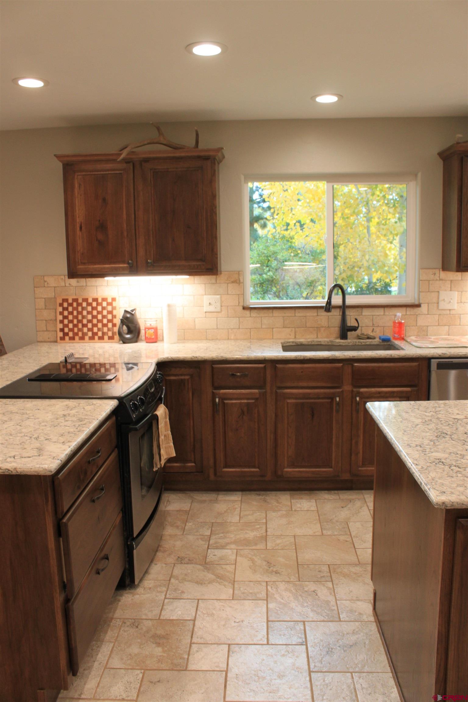 20976 6840th Road Montrose, CO 81403 - Photo 5 of 33 a kitchen with a sink stove top oven and cabinets
