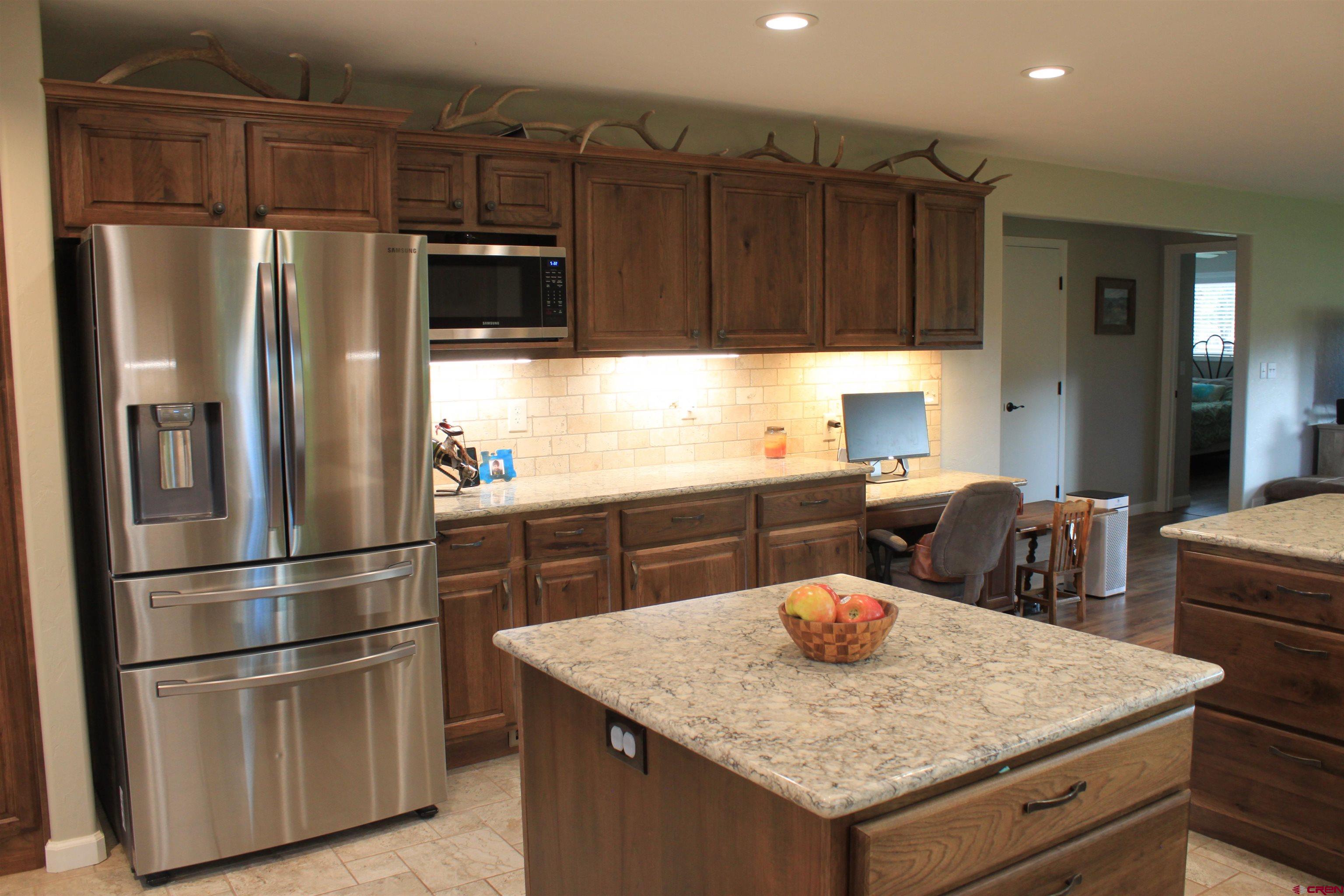 20976 6840th Road Montrose, CO 81403 - Photo 6 of 33 a kitchen with stainless steel appliances granite countertop a refrigerator a stove and a sink