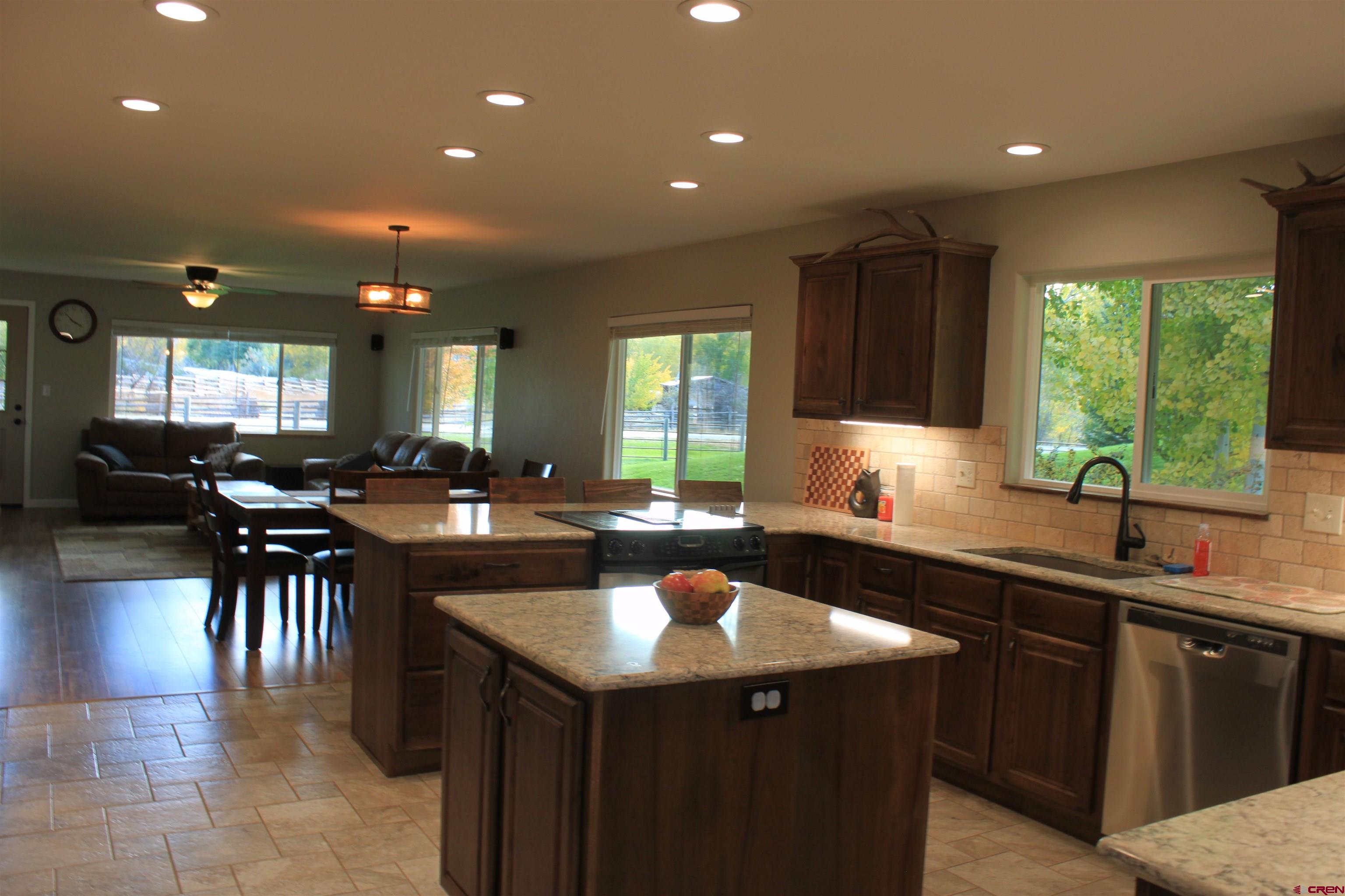 20976 6840th Road Montrose, CO 81403 - Photo 7 of 33 a kitchen with a sink and a stove top oven with wooden floor