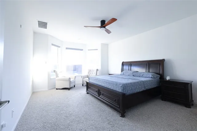 a bedroom with a bed and window