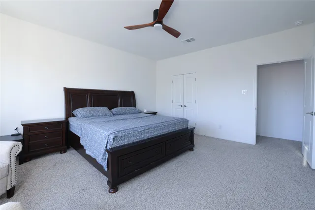 a bedroom with a bed and dresser