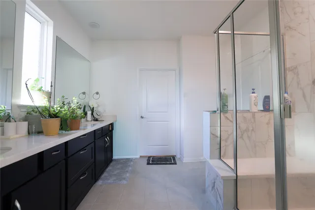 a bathroom with a shower and a sink