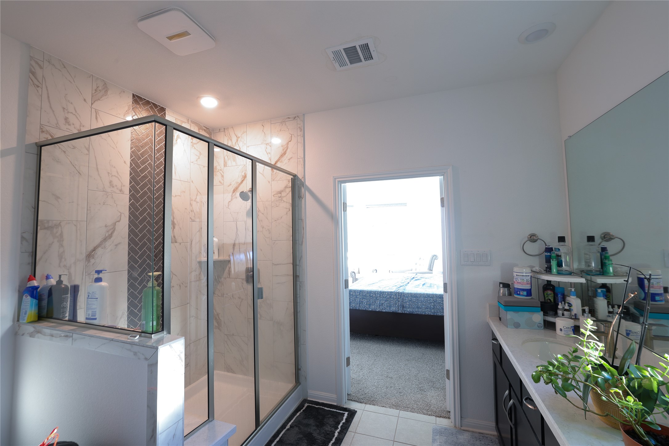232 Barton Oak Trail Georgetown, TX 78628 - Photo 19 of 19 Ensuite bathroom with vanity, a marble finish shower, light carpet, and light tile patterned flooring