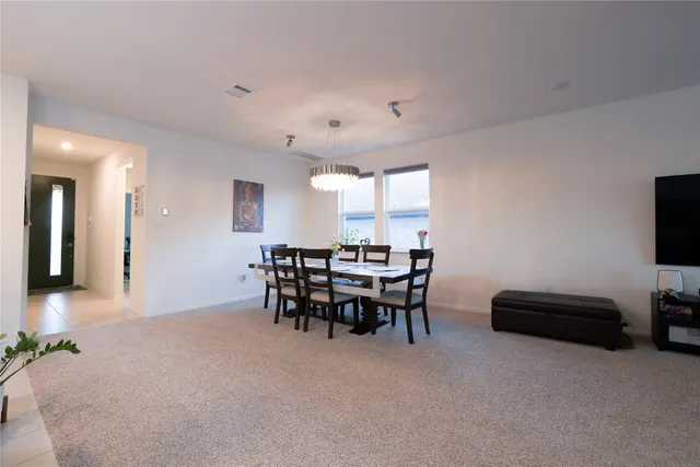 a view of a livingroom with furniture and a flat screen tv