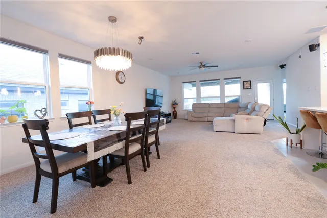 a view of a dining room with furniture and a large window